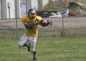 Hazen senior James Holland catches a pitch in practice.