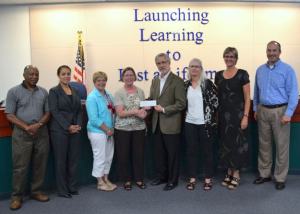 The Friends of Renton Schools recently presented the Renton School Board with a check.