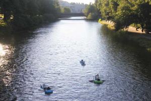 Three residents float into Monday's sunset along the Cedar River in downtown Renton.