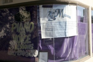 Purple paper covers the windows of 'N Time Music Productions in downtown Renton. Still visible are the promotions for piano and voice lessons and the mission statement of Royce Shorter's ministry