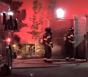 Firefighters battle a dumpster fire Thursday morning.