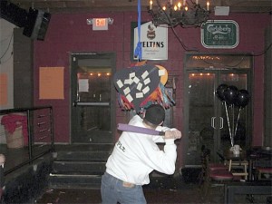 Attendees at The Berliner's Anti-Valentine's Day Party took turns swinging at a piñata labeled with the names of their ex-boyfriends and ex-girlfriends Thursday night in Renton.