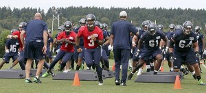 No. 3 Russell Wilson lead the Seahawks through a practice at the team's training center in Renton. Wilson signed a four-year contract extension this week.