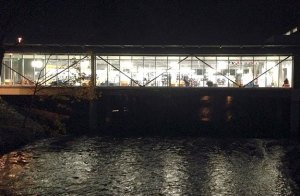 Silhouettes of residents can be seen in this shot of the downtown library lighting up the Cedar River on a recent