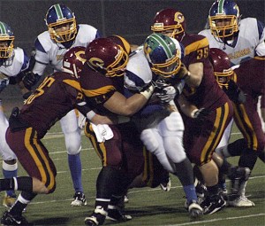 Hazen's Cody Taylor gets pushed back by the Capital defense Saturday night.