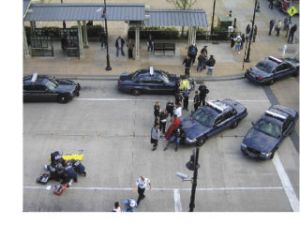 Renton Fire Department medics work on a 74-year-old stabbing victim Thursday evening at the Renton Transit Center on Burnett Avenue South