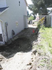 Police tape is removed Thursday from the site where human remains were excavated at a new home under construction on Edmonds Avenue Northeast. The remains are likely decades-old.