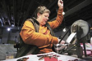 Kris Hill does the final assembly of a No. 1-5 Jack Lloyd All Diamond Troll Wednesday at her parents’ home in Renton. Hill’s parents bought the fishing tackle company in 1976 and have run it from their home ever since. Some of the tools they use date back to the company’s founding in 1916.