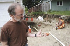 Famed forensic anthropologist Dr. James Chatters – the discoverer of Kennewick Man – displays a part of the metal work of a coffin Friday in which a young man was buried in the Highalnds in early years of the 1900s.