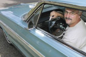 Gordy Runge sits in his 1964 Chevrolet Impala SS