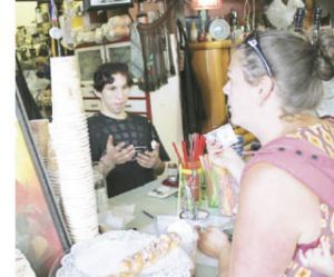 Jet City Espresso barista Patrick Balles serves Jessica Smith