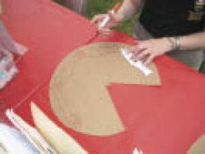 A visitor to the Renton History Museum’s Renton River Days booth makes a brown-paper hat in the style of Native Americans. The museum received a $10