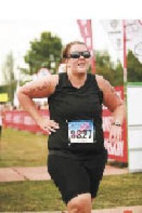 Rachel O’Brien of Renton crosses the finish line in the Danskin Triathlon last weekend as her parents watch.