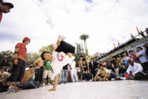 A breakdancer shows off his moves in the Seattle Center during last year’s Bumbershoot music and arts festival. The event – which features live music