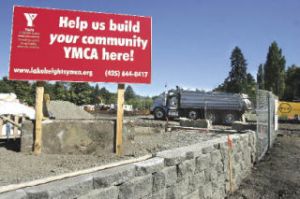 A dump truck delivers dirt to the future site of Coal Creek YMCA