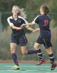 Lindbergh’s Whitney Hilde and Sarah Aylward celebrate a goal by Hilde in the first half against Renton Tuesday