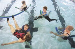 Volunteer Arlene Fowler of Seattle holds volunteer Roberta Koller of Renton