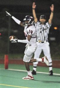 Lindbergh wide receiver Diondre Toms celebrates a touchdown he scored by making a leaping catch in the back of the endzone Friday against Renton at Renton Memorial Stadium.