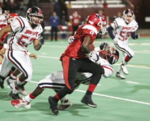 Renton High’s Ronnielle Kelly-Battles runs over Kennedy’s Tre Watson