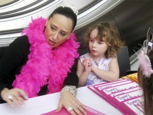 “Fancy Nancy” illustrator Robin Priess Glasser signs books as Ilaria Kaiser looks on.