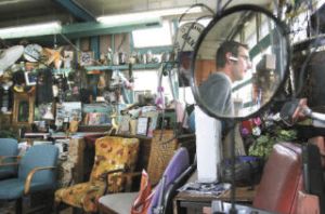 Ryan Runge of Renton is reflected Wednesday in mirror as he leaves Jet City Espresso