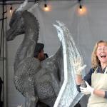 Kim Beaton poses in front of &ldquo;Brienne,&rdquo; an eight-foot tall dragon sculpture made from Pal Tiya, at RenCon.