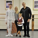 Teenage dancer pirouettes behind parents’s footsteps