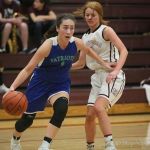 Liberty Patriots junior guard Sydney Argosino, left, drives to the basket against the Mercer Island Islanders on Jan. 4. Mercer Island defeated Liberty 64-29. Photo courtesy of Don Borin/Stop Action Photography