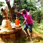 Samuel Irungu demonstrates what it would take to collect water from a well in Kenya during a visit to his home country last year.                                Courtesy of Samuel Irungu