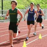 Freshmen Aiden Holmes (in front) and Alex Chin run the 1600 meters during Thursday&rsquo;s meet. Chin came in fourth followed by Holmes in fifth place.
