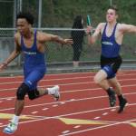 As part of Liberty&rsquo;s 4x100 meter relay team, sophomore Jarod Roberson (left) waits for the hand off from sophomore Ryan Kirschner.