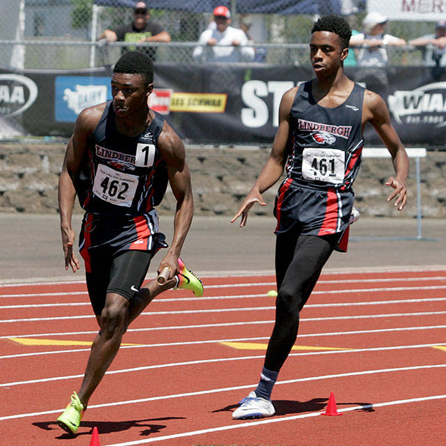 Lindbergh&rsquo;s Josh Bass hands off to Deven Brown during the 4x100 relay. Photo by Dennis Box