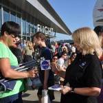 Leslie Williams, news chief for the NASA Armstrong Flight Research Center, right, gives NASA stickers to eclipse-goers at the Museum of Flight. HEIDI SANDERS, Reporter