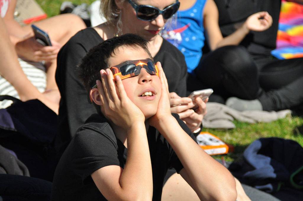 James Yunger, 13,of Bellevue views the eclipse through special glasses. HEIDI SANDERS, Reporter