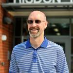 Principal Craig Cooper poses in front of the school. (Leah Abraham | Renton Reporter)