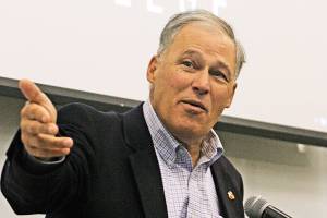 Gov. Jay Inslee talks to a Green River College student during his visit to the Auburn campus last week to discuss climate change. MARK KLAAS, Kent Reporter