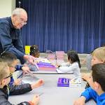 Renton Rotary members hand out dictionaries to third graders