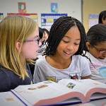Renton Rotary members hand out dictionaries to third graders