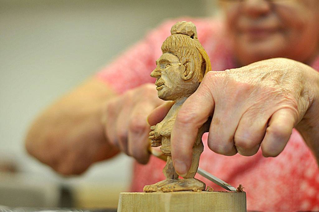 Sue Hasbrook puts the finishing touches on her figurine. (Leah Abraham | Renton Reporter)