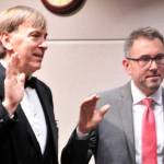 Randy Corman, left, and Armondo Pavone, right, take their oath of office Jan. 8. (Leah Abraham | Renton Reporter)
