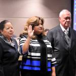 Ruth Perezs parents stand beside her as she is sworn into office Jan. 8. (Leah Abraham | Renton Reporter)