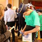 A child distributes raffle tickets to a Celebration of Youth luncheon attendee. Raechel Dawson/staff photo