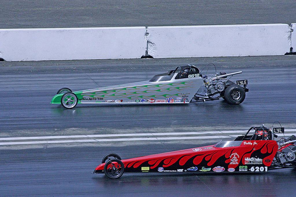 Rentons Ryan Warnke, above, duels Bobby Burkevies Jr., during a qualifying run in the Junior Dragster Lightning category at Pacific Raceways last Saturday. Area teams converged at the drag strip for the inaugural Mark Lyle Junior Invitational, a tribute race for the late NHRA chief official starter who began his career at the Kent track. MARK KLAAS, Kent Reporter