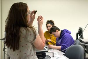 A Renton Technical College student demonstrates what the students will be building for the Girls Exploring Tech camp. Photo by Kayse Angel