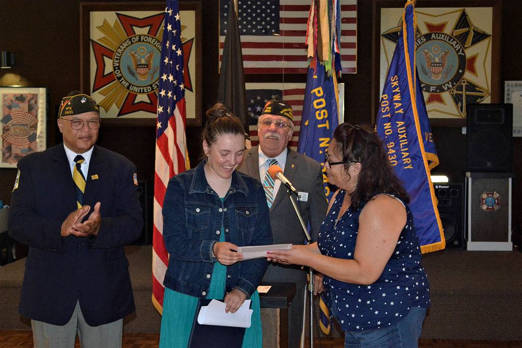 Skyway VFW Post 9430 auxiliary president Emma Hassebroek presents a $1,000 check to Rachael Reed, awarded for the Patriots Pen essay contest.