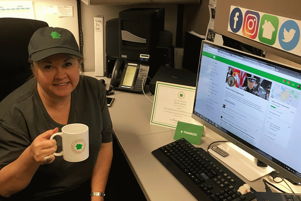 Photo courtesy of Nextdoor                                Sandra Havlik sports her Neighborhood Champion kit from Nextdoor from her Renton Police Department desk where she manages social media accounts.
