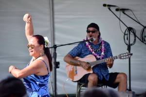 Headliner for Polynesian Festival Bruddah Waltah, who traveled from Hawaii to perform, plays while his wife of 43 years, Thailiana, dances on Saturday Aug. 18.