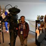 Sean Shaw, who traveled from Los Angeles for the convention, poses for a photo with Bianca and Angel, local Renton students, in his Black Manta cosplay. Shaw was also a judge in RenCons prop contest, and said he was blown out of the water by the creations.
