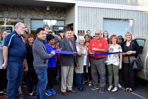 Photo By Haley Ausbun.                                The Renton Kiwanis Clothes Bank celebrates its new location with city and chamber representatives Oct. 16. The new location opened in May and offers clothing for those in need.