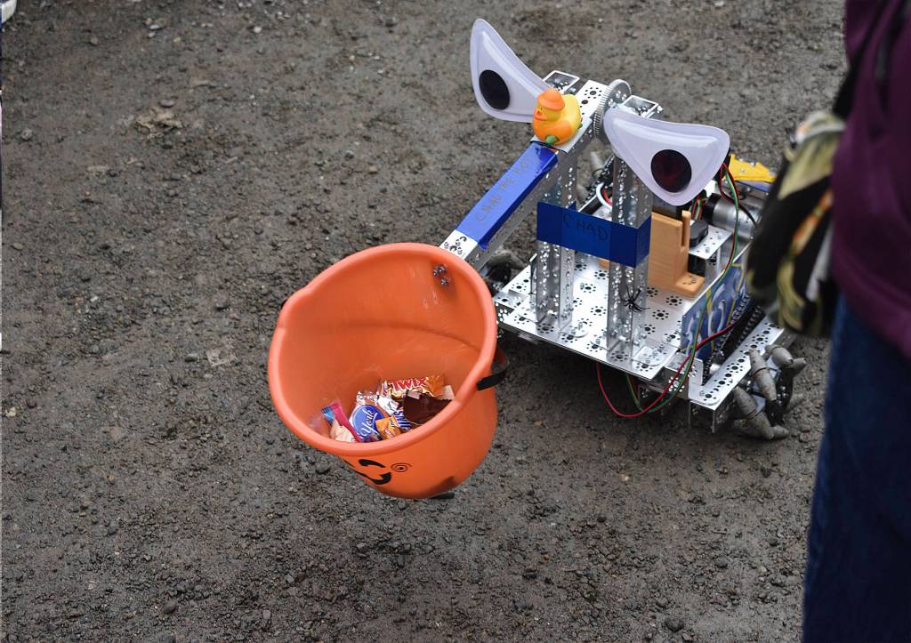 Bot Chad offers trick-or-treaters candies, courtesy of Hazen High Schools robotics team 8693.
